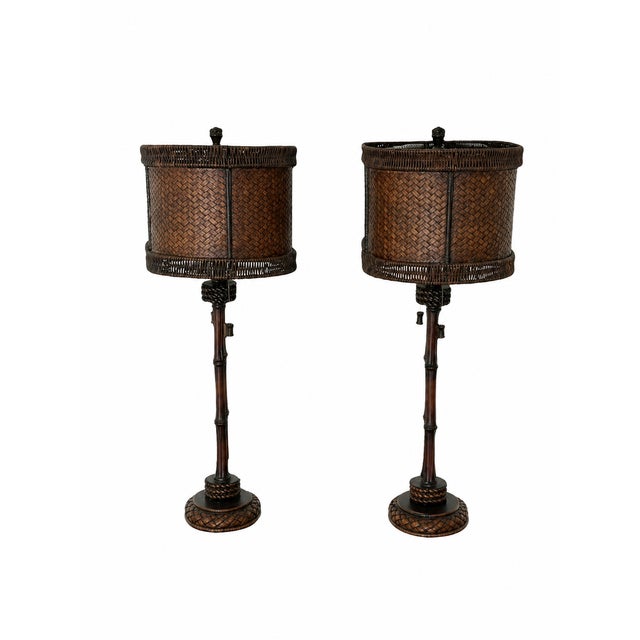 Pair of faux bamboo table lamps with woven shades. The lamps have a bamboo-like design and come with matching woven...