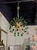 The "Modern Green and Brass Sputnik Chandelier" features a modern Murano design with a sleek brass frame, adding a touch...