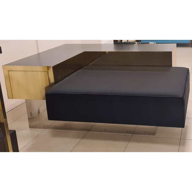 Artisan sofa in brass, steel, wood and silk satin. Almost square form, it was part of the furnishings of a famous shop in...