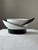 This designer cup by Uta Feyl stands out with its contrast of black and white and its sharply defined geometric forms,...
