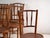 A set of six antique chairs in bentwood, with a curved crest rail over vertical splats and a moulded board seat....