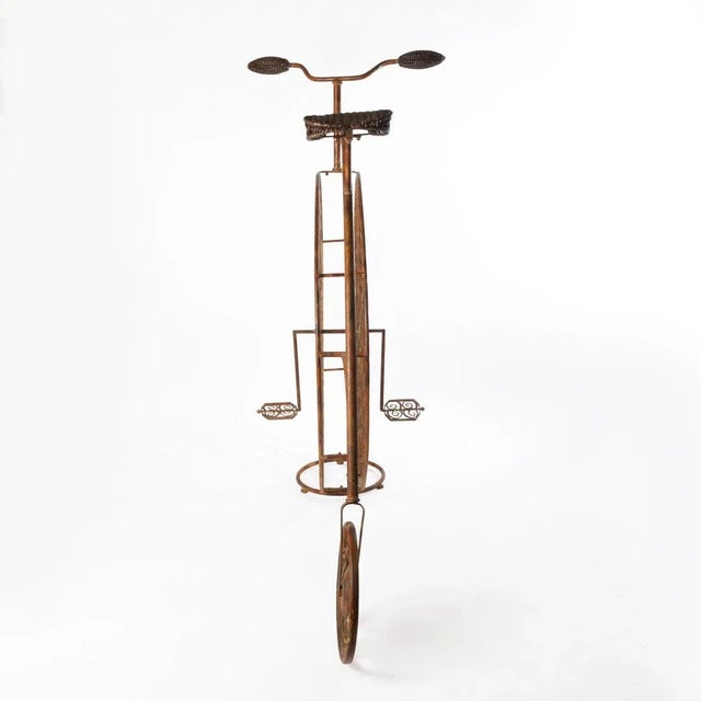 Vintage high wheel bicycle wine rack. Wonderful piece, handles and peddles can be removed if needed to reduce space.