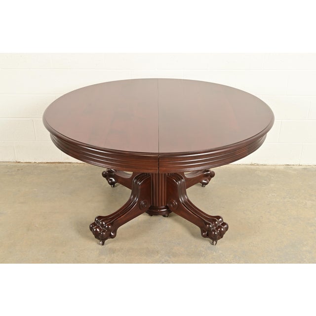 An outstanding antique Victorian or American Empire split pedestal extension dining table Attributed to R.J. Horner & Co....