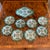 A charming set of eight Fitzhugh Pattern butter plates in green, together with a matching small vegetable serving dish....
