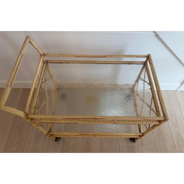 Metal bar cart, hand painted to resemble bamboo. Two glass shelves. On castors. Fantastic poolside, sunroom! Very good...