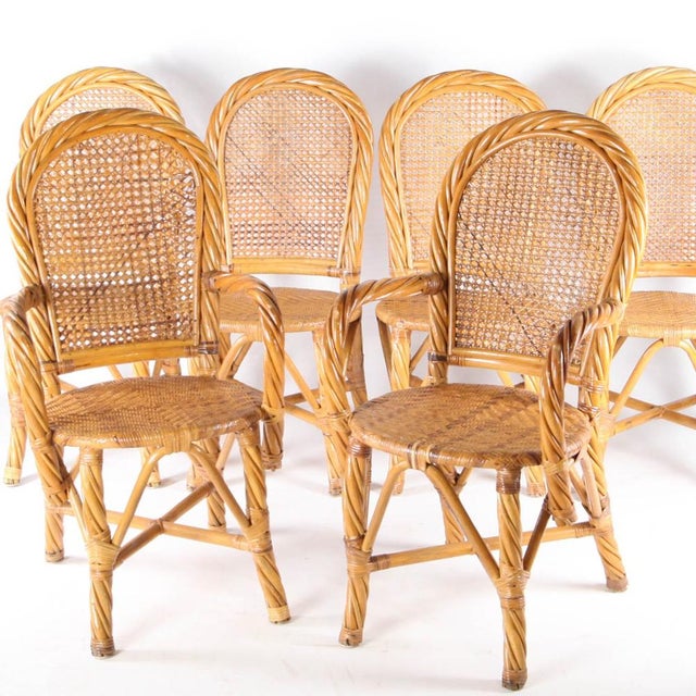 Exceptional woven rattan dining room set from the 1970s, comprising a table, two armchairs, and four chairs. High-quality...