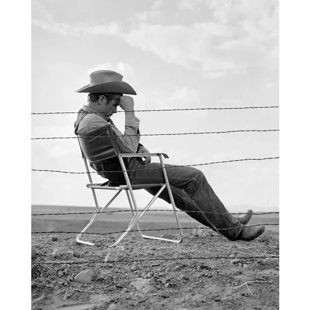 James Dean Behind Fence in "Giant" James Dean posed sated behind a barbed wire fence for his role in the film 'Giant',...