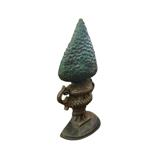 A charming, vintage cast iron door stop. Features a cast iron door stop in the form of a boxwood topiary in a handled urn....