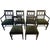 A set of dark wood dining chairs with upholstered seats and distinctive oval cutout backs.