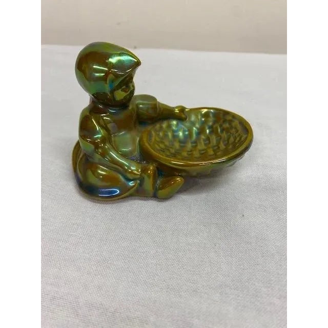 Famous for it's green finish, this figurine is a great example of Zsolnay's eosin finish From Hungary's Art Deco period.
