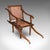 This is an antique ladies Colonial veranda chair. An English, beech and cane extending carrying seat, dating to the late...