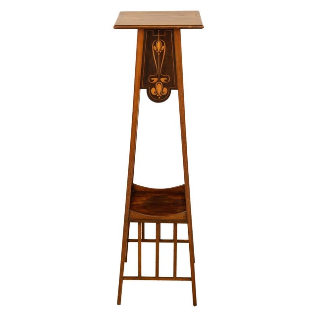A very elegant antique tall Art Nouveau mahogany inlaid plant stand, designed by Leonard Wyburd and retailed through...