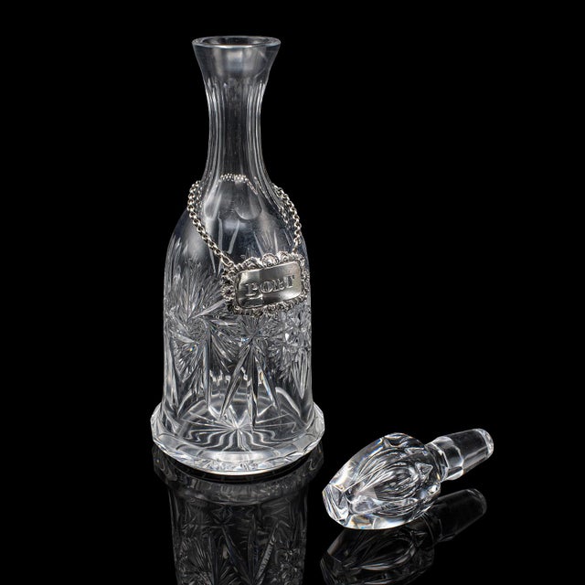 This is a vintage port decanter. An English, cut glass and silver spirit bottle, dating to the mid 20th century, circa...
