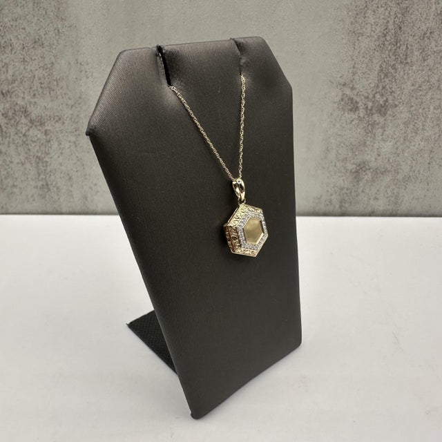 Add a meaningful touch to your collection with this elegant Diamond Locket, crafted in 10kt Yellow Gold. Featuring 0.10...