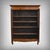 A Loire Valley bookcase in solid cherry wood, distinguished by its classic elegance and the quality of its craftsmanship....