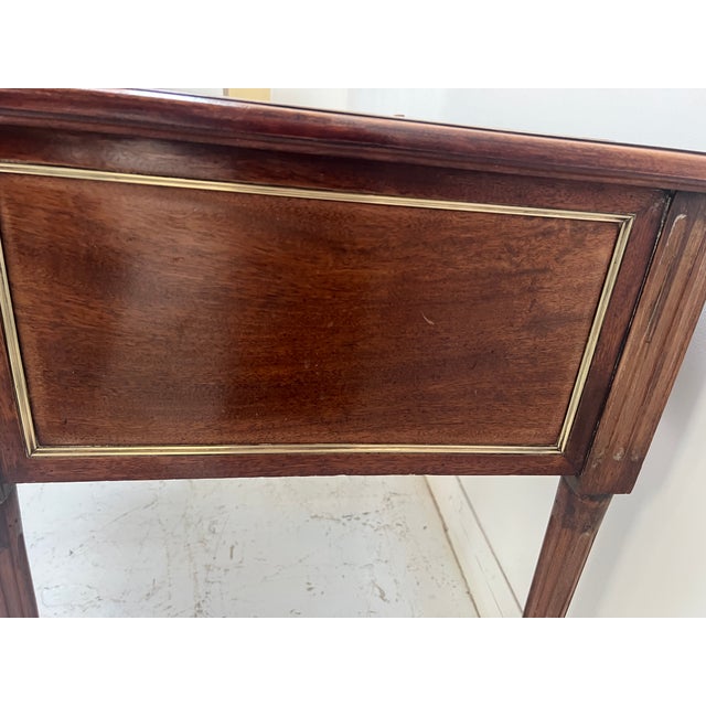 Louis xvi style desk in mahogany and mahogany veneer it rests on four tapered legs with recessed fluting four drawers in...