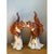 These vintage ceramic figures are a mirrored pair of squirrels, each perched on a tall, tapering tree stump and facing...
