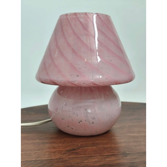 Beautiful mushroom-shaped table lamp. Italy, 1970s. Made entirely of pink Murano glass. Spirally striated and speckled...