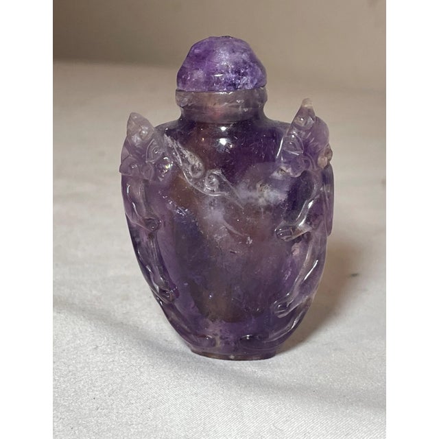 Up for sale is a rare antique hand carved Chinese natural amethyst stone snuff bottle. The bottle is carved out of a dense...