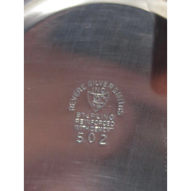 Weighted base with ruffled rim on a tall trumpet form. marked Revere Silversmiths and serial numbers on the bottom....