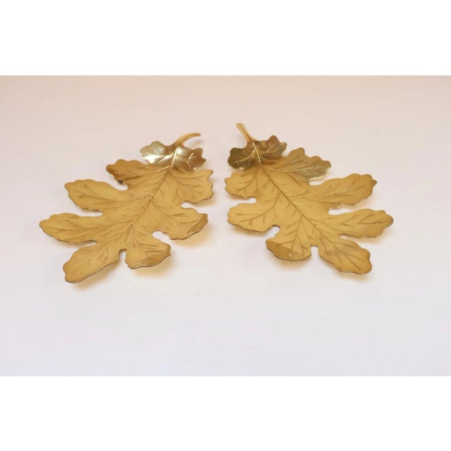 Pair of elegant brass leaf catch-all dishes ideal for displaying small items given their diminutive size (ca. 1970s, USA)....