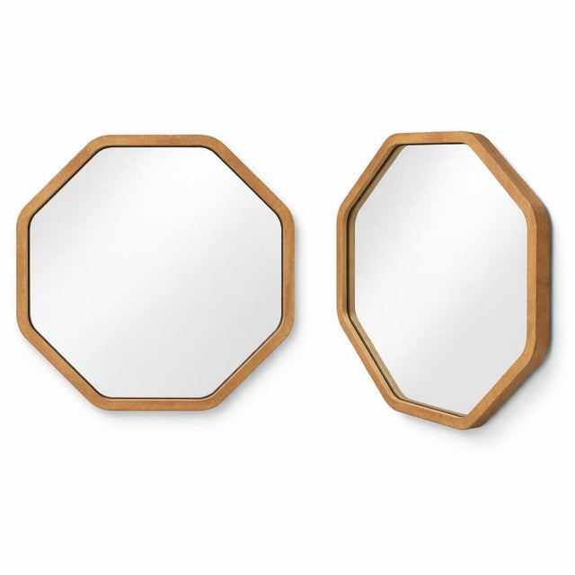 A charming vintage octagonal wall mirror framed in oak, featuring a clean geometric silhouette that reflects early to...