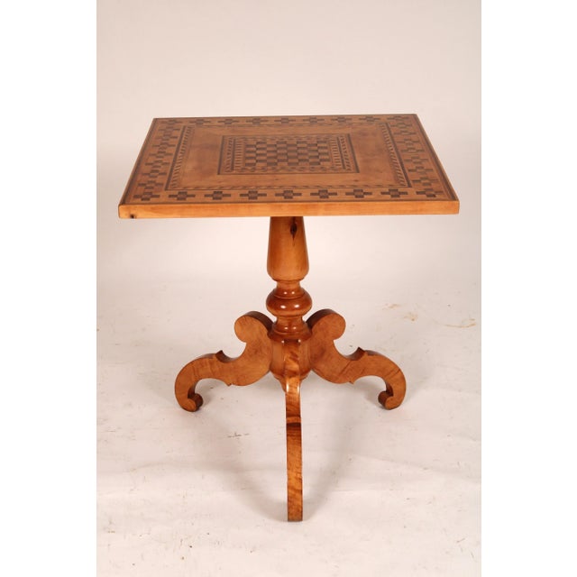Antique Biedermeier style birch inlaid tilt top table, circa 1900. With a square top with walnut parquetry and banding, a...