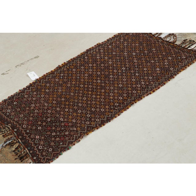 This vintage 4x7 Turkish Kilim is handwoven in wool, and originates circa 1950-1960. Its colorway is polychromatic, though...