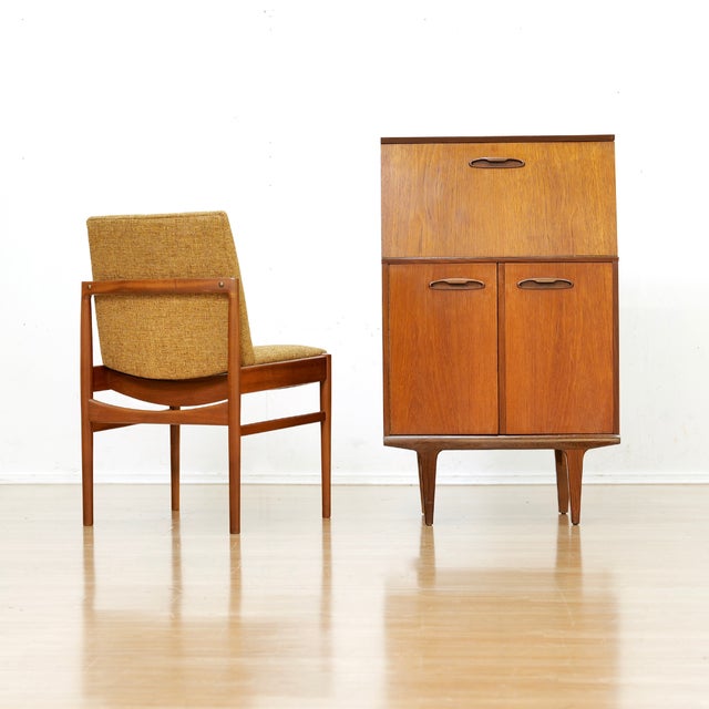 This fabulous mid century drinks cabinet was manufactured in Denmark during the 1960s. The teak cabinet has a warm, rich...