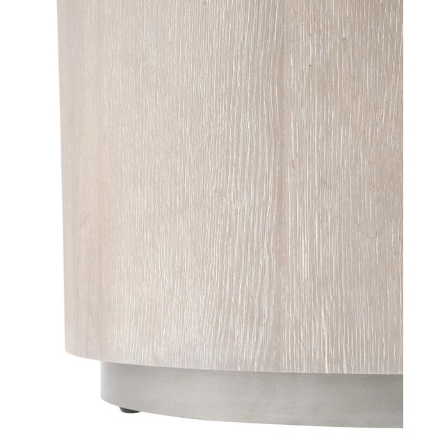 Furnish your living space with this simple but statement-making round end table. With its neutral tones and minimalistic...