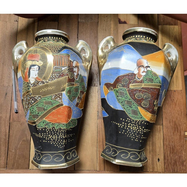 Pair of polychrome glazed earthenware and gold vases - Japan, Satsuma kilns Decorated with traditional Japanese figures,...