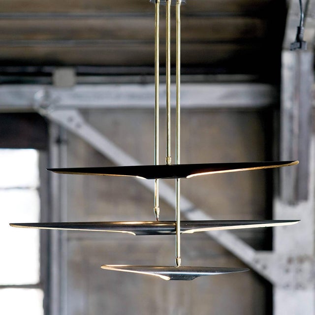 The aerodynamic Concorde chandelier, inspired by a supersonic airliner, wears a sleek Blackened Iron finish with...