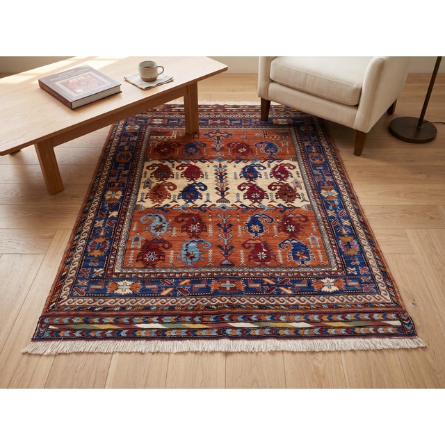 This finely hand-knotted wool rug reinterprets a classic Kazak tribal design, with rows of stylized ram's-horn medallions...