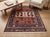 This finely hand-knotted wool rug reinterprets a classic Kazak tribal design, with rows of stylized ram's-horn medallions...