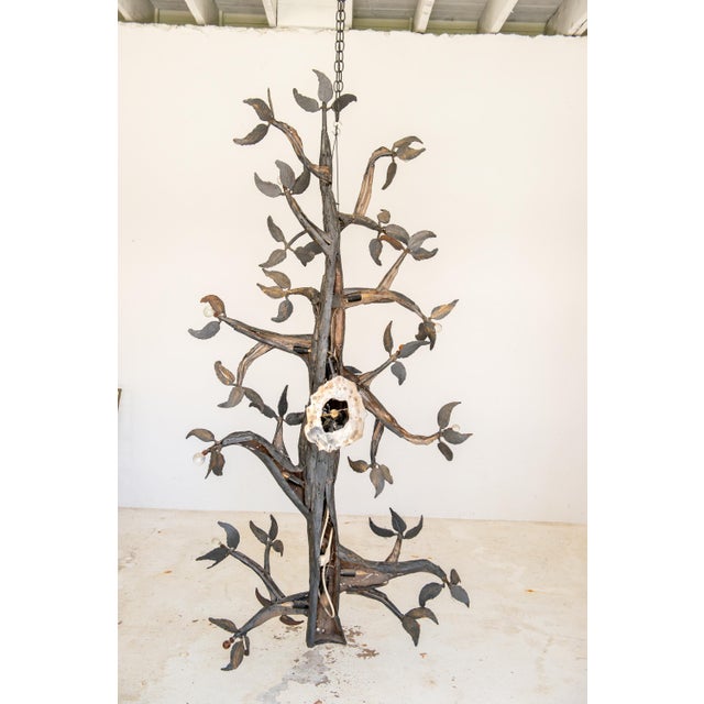 This sculpture is a large welded metal tree with wrought iron foliage and ends of branches decorated with crystal balls....