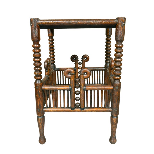 Square top with bobbin turned legs joining stick and bentwood decorative stretcher. Circular tapered legs.