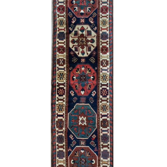This remarkable early 20th-century Persian Azerbaijani Kuba runner is a vibrant example of traditional craftsmanship and...
