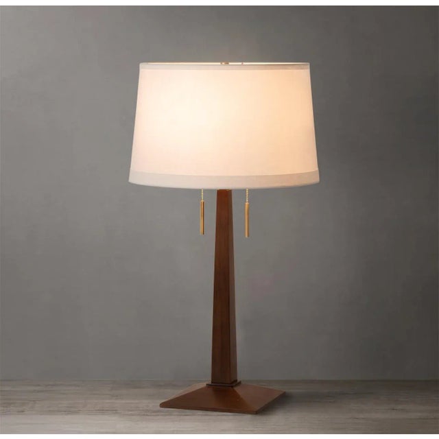Bring the timeless beauty of mid-century modern design to your space with the Taper Table Lamp. With its classic dark...