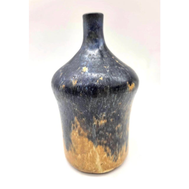 Offered is a circa. 1970s wheel-thrown ceramic glazed stoneware bud vase with a narrow vertical neck, broad shoulder, and...