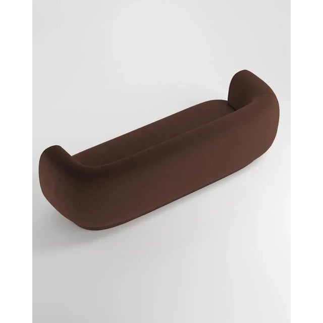 Hug sofa is defined by clean, simple lines and a distinctive armrest detail. The armrest, half overlapping the seat...