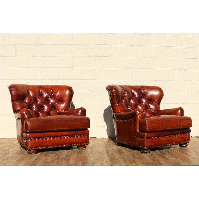 Exceptional pair of vintage Churchill club chairs by Henredon from the 1990s, upholstered in rich distressed brown leather...