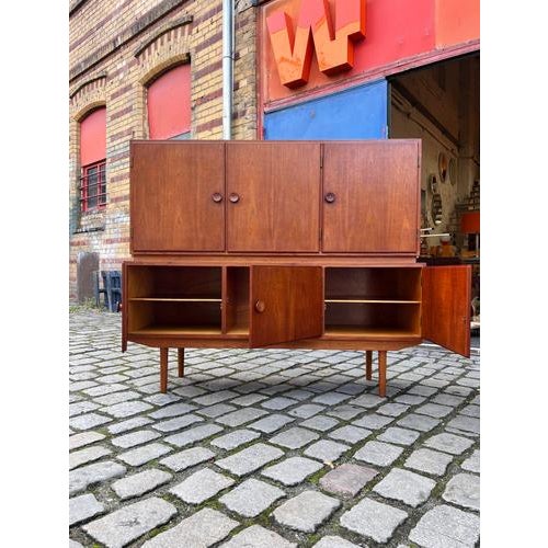 An impressive highboard from Denmark, captivating with its balanced proportions and exquisite craftsmanship. A second...