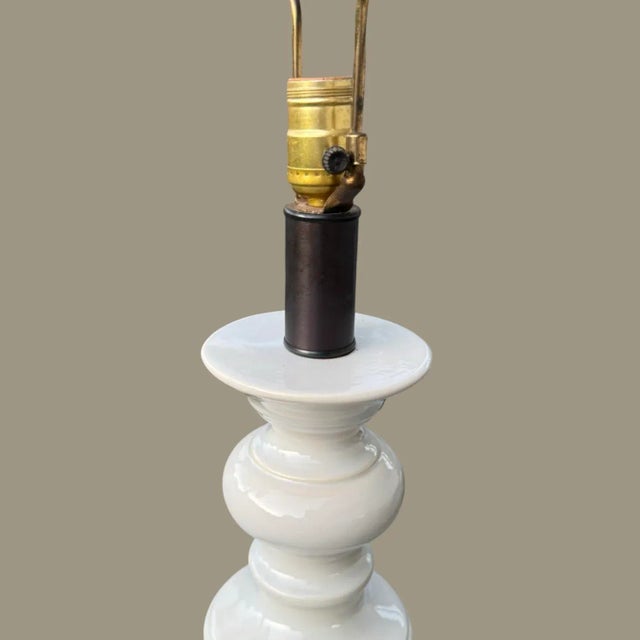 Vintage tall white ceramic spool lamp from the 60’s era with original wiring, 3 way switch. Lamp measures 38.5” to the top...