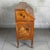 An elegant secretary desk with a drop-down top, attributed to an Italian workshop from the early 20th century and inspired...