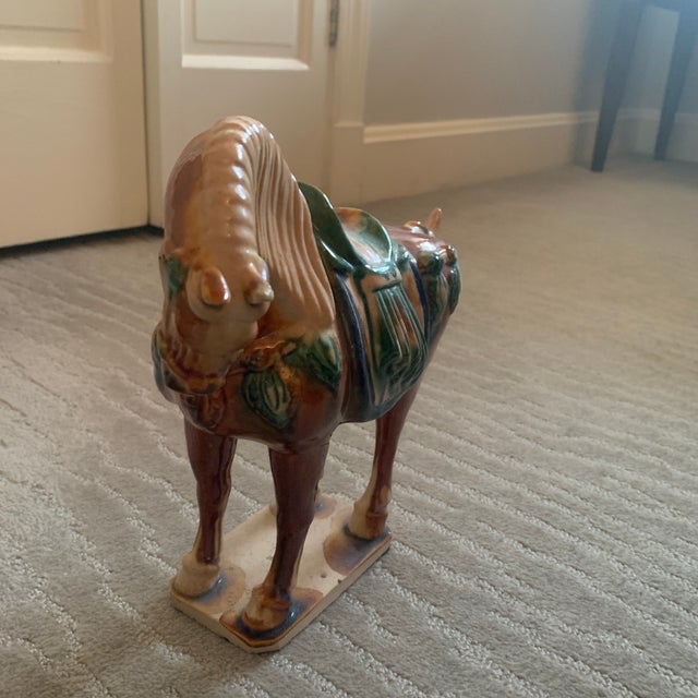This lovely horse is posed in a resting position. Its colors are vibrant and picks up fine details. The small pedestal is...