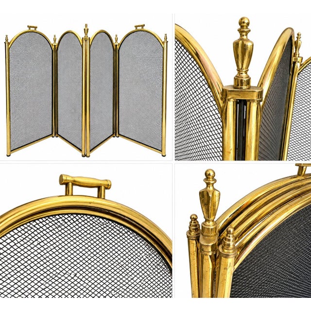 A beautiful antique fireplace screen with a four-panel brass frame and dark mesh panels. The curved design, warm brass...