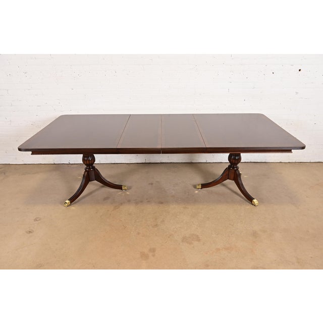 An exceptional Georgian or Regency style double pedestal extension dining table In the manner of Baker Furniture Circa...