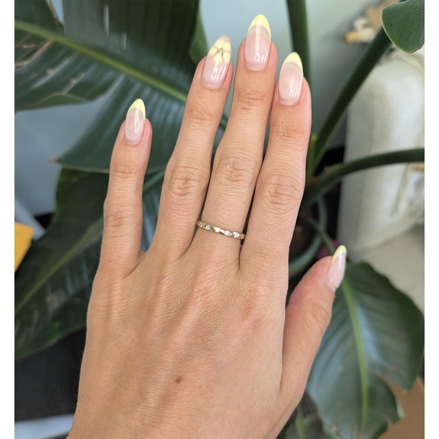 This minimalist diamond band is crafted in solid 14K gold and features a refined row of brilliant round diamonds for a...