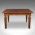 This is an antique kitchen diner table. An English, solid walnut four seat dining table, dating to the Edwardian period,...