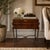 An elegant English Regency Revival storage side table featuring a hinged rectangular top with geometric line inlay and a...